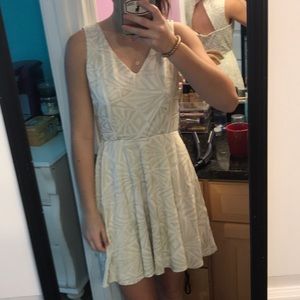 A white and gold shirt dress